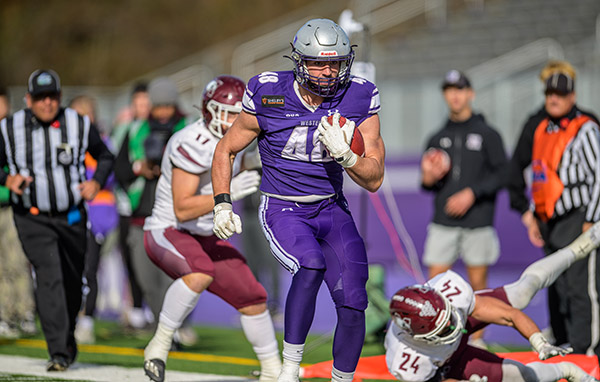 Sandro Pierini in his Western football gear running with a football