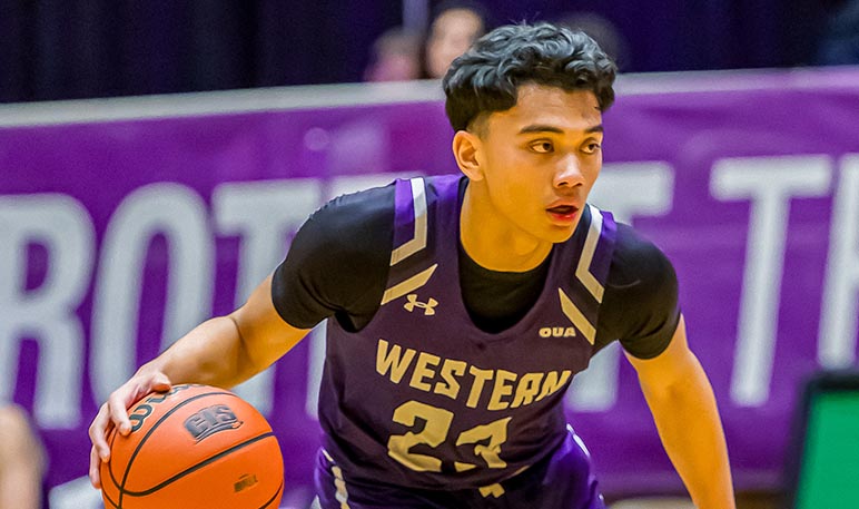 Western Mustangs men’s basketball player dribbling the ball