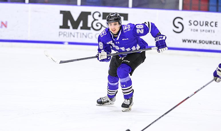 Western Mustangs men’s hockey players celebrating a goal