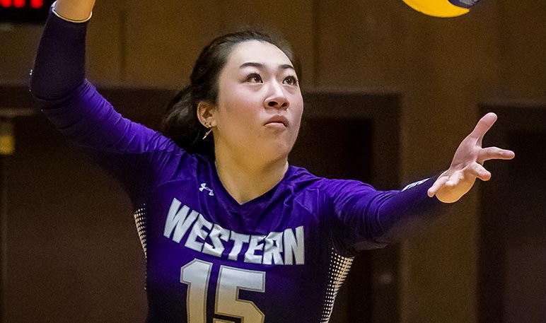 Western Mustangs women’s volleyball team celebrating on the court