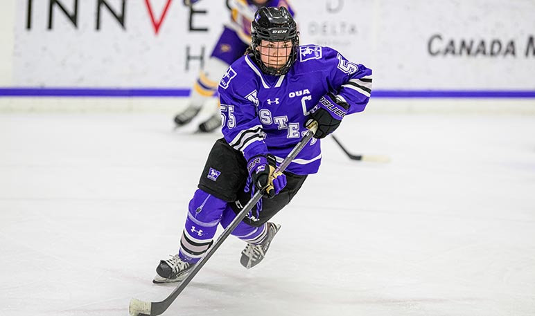 Western Mustangs women’s hockey goalie saving a shot