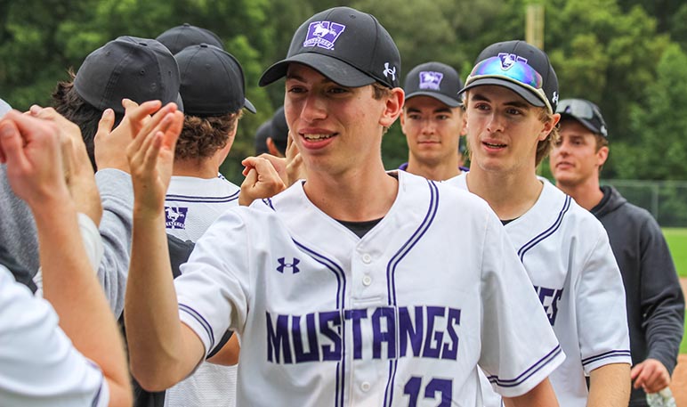 Western Mustangs baseball pitcher lunging and throwing the ball