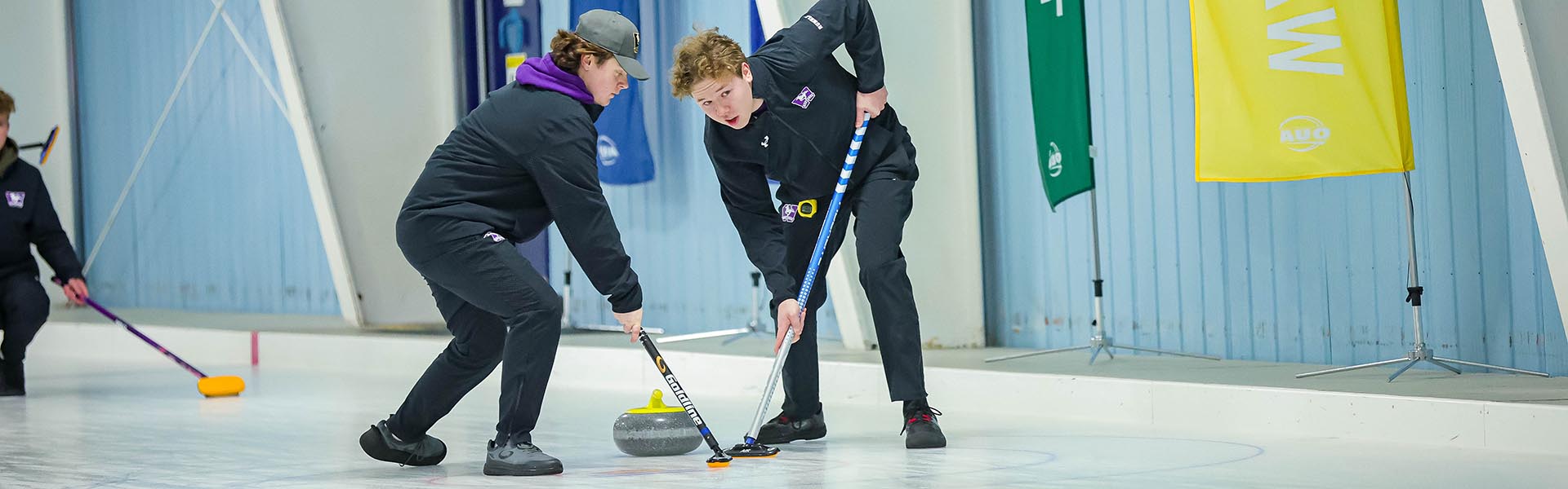 Western Mustangs men’s curler delivering a stone