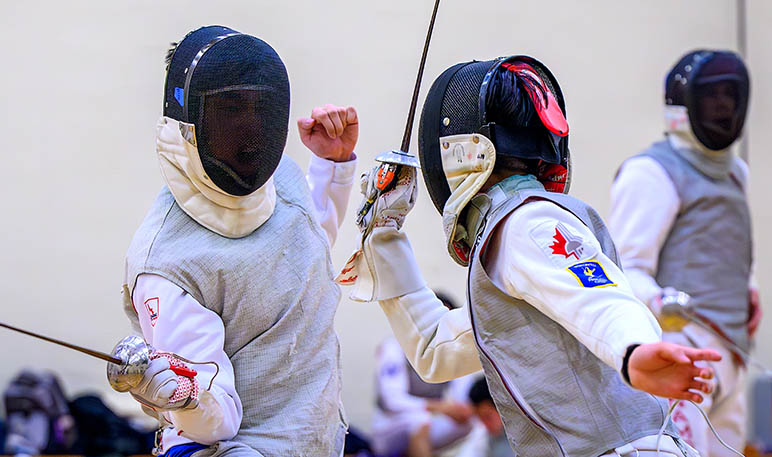 Western Mustangs fencer defending an attack