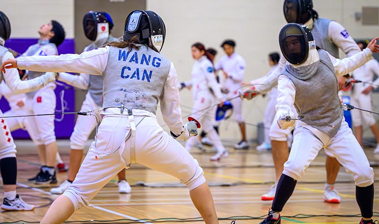 Western Mustangs fencer defending an attack