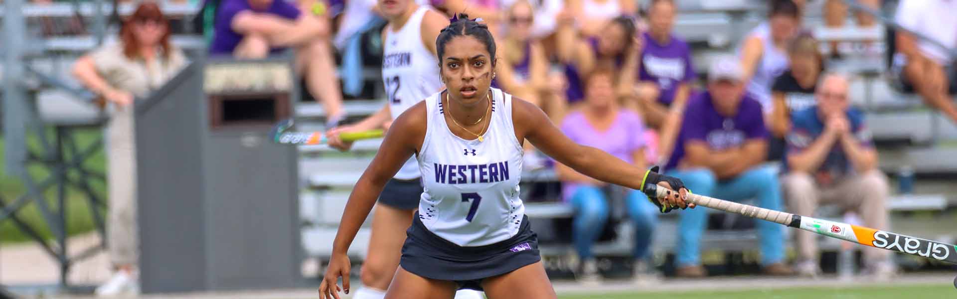 Western Mustangs field hockey player swinging her stick