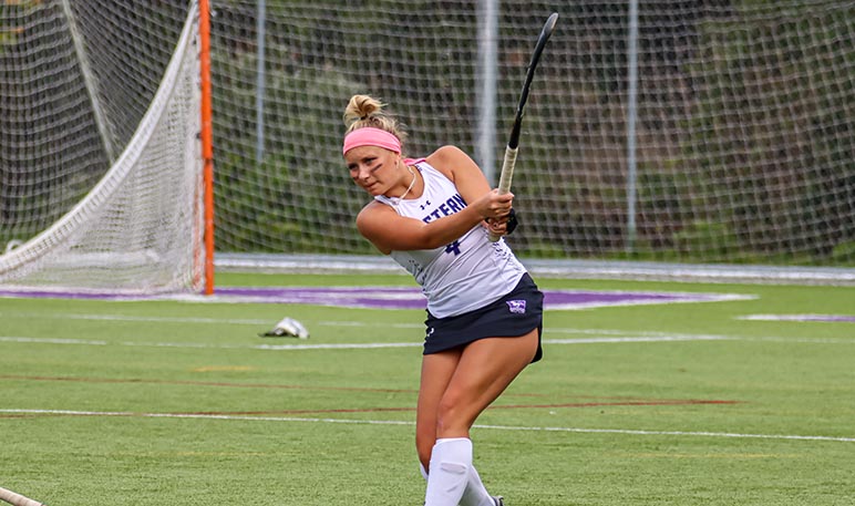 Western Mustangs field hockey player running with her stick