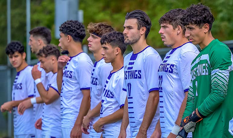 Western Mustangs men’s soccer player running in the rain