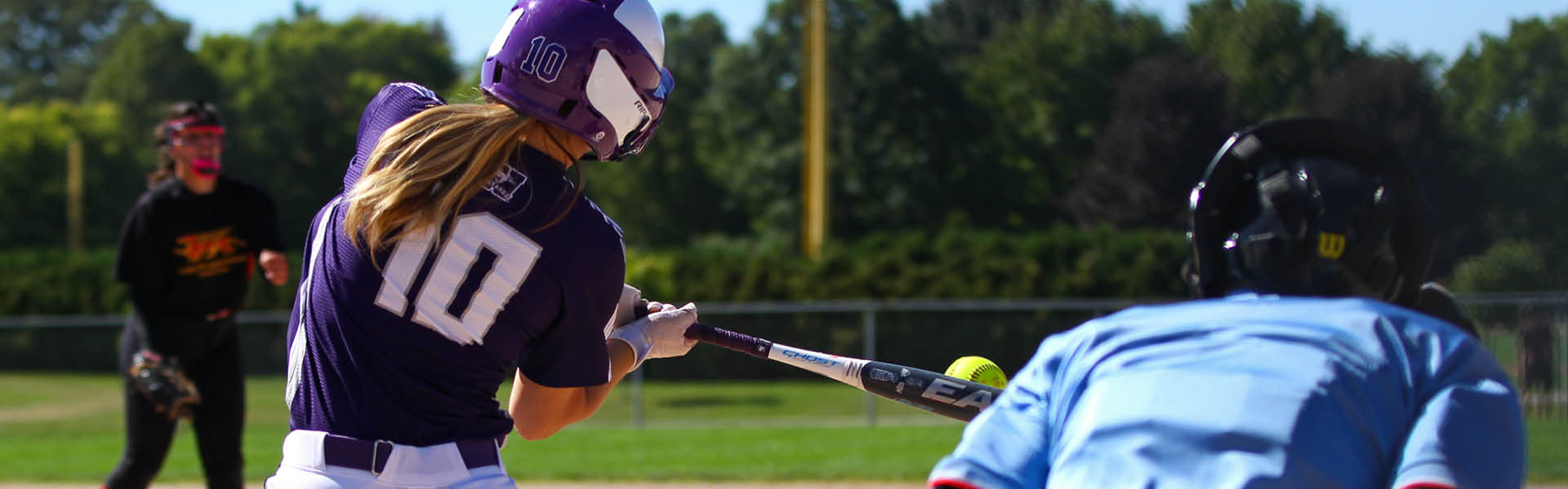 Western Mustangs softball player batting at home plate
