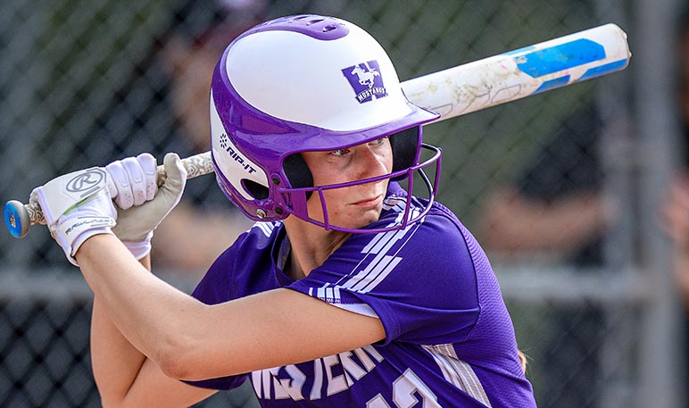 Western Mustangs softball player throwing the ball