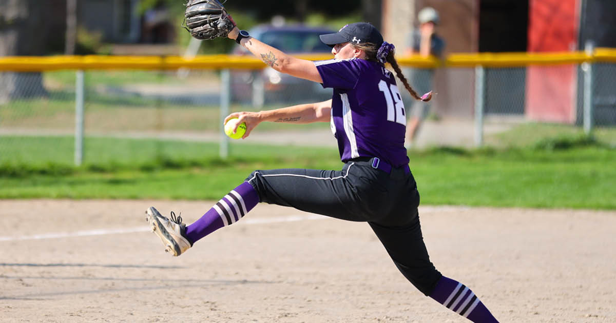 Western Mustangs softball pitcher lunging and throwing the ball