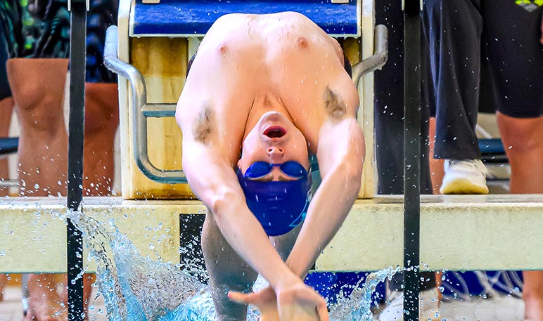 Western Mustangs male swimmer doing the butterfly stroke