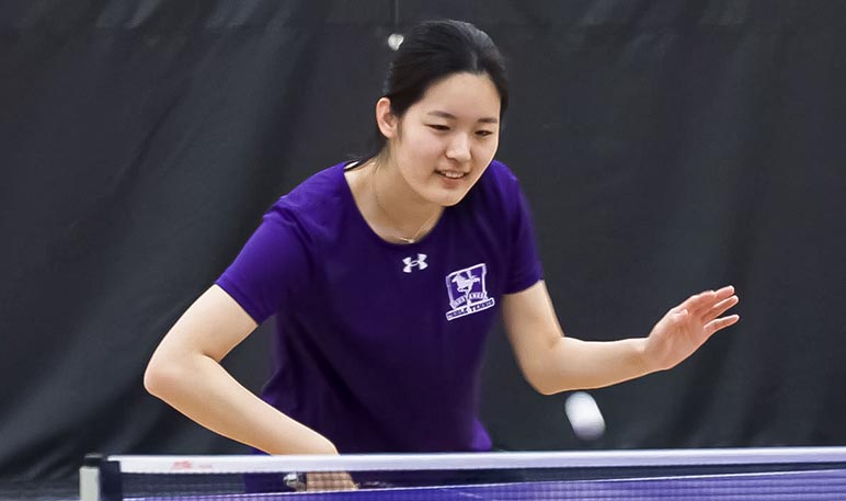 Western Mustangs table tennis player serving the ball