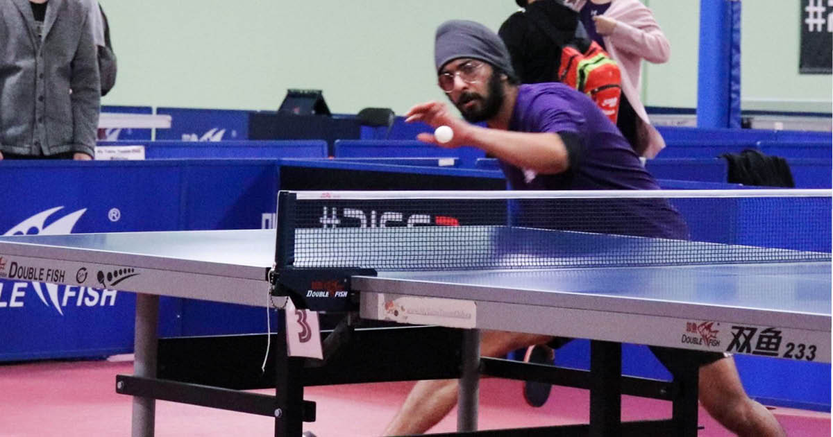 Western Mustangs male table tennis player mid-game