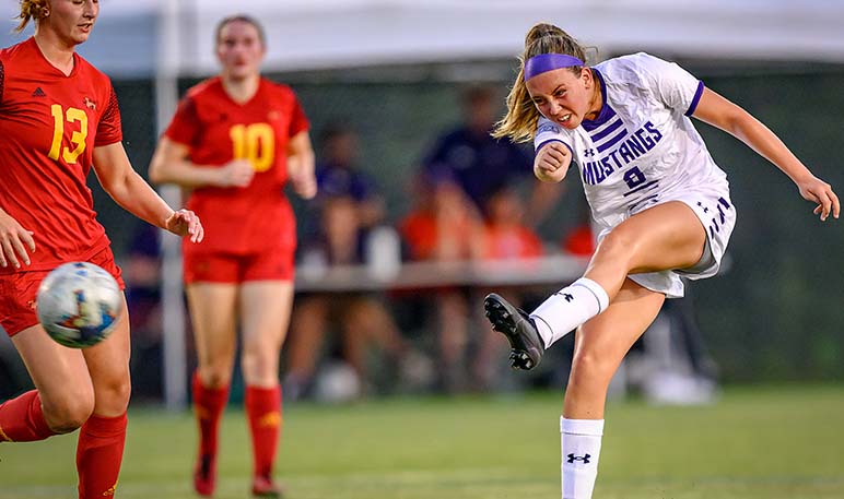 Western Mustangs women’s soccer goalie kicking the ball