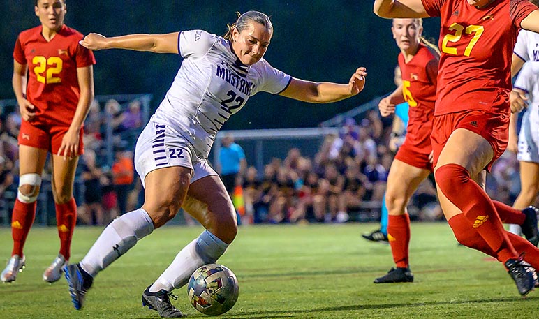 Western Mustangs women’s soccer player chasing down the ball