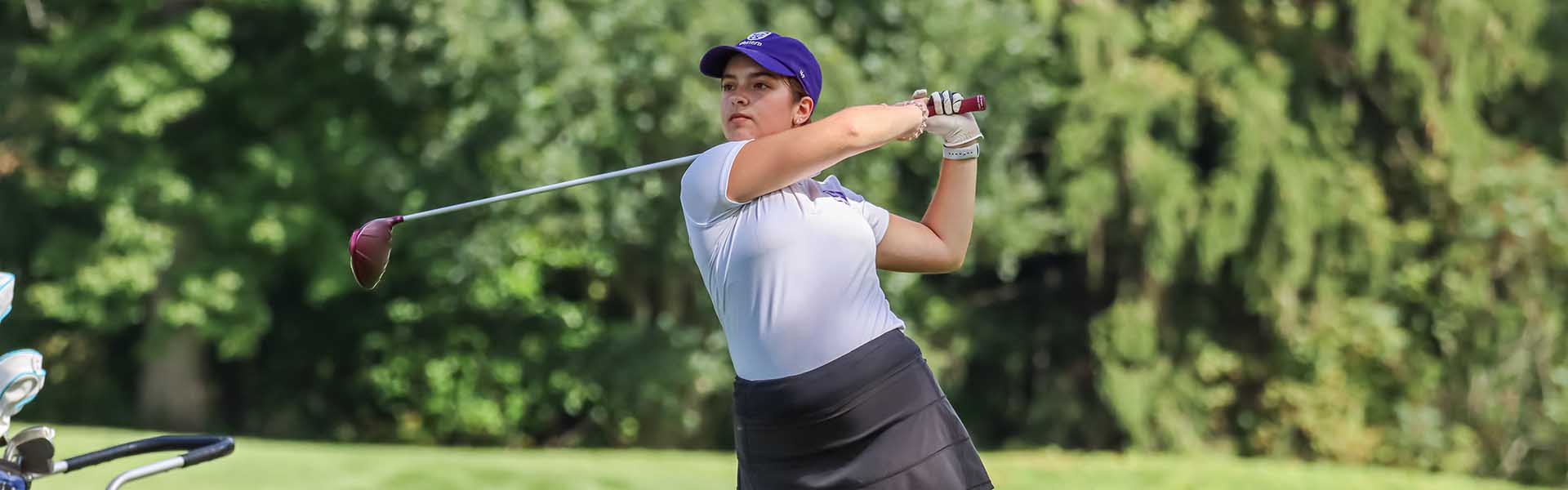 Western Mustangs women’s golfer swinging her club