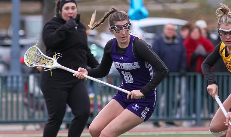 Western Mustangs women’s lacrosse goalie catching the ball