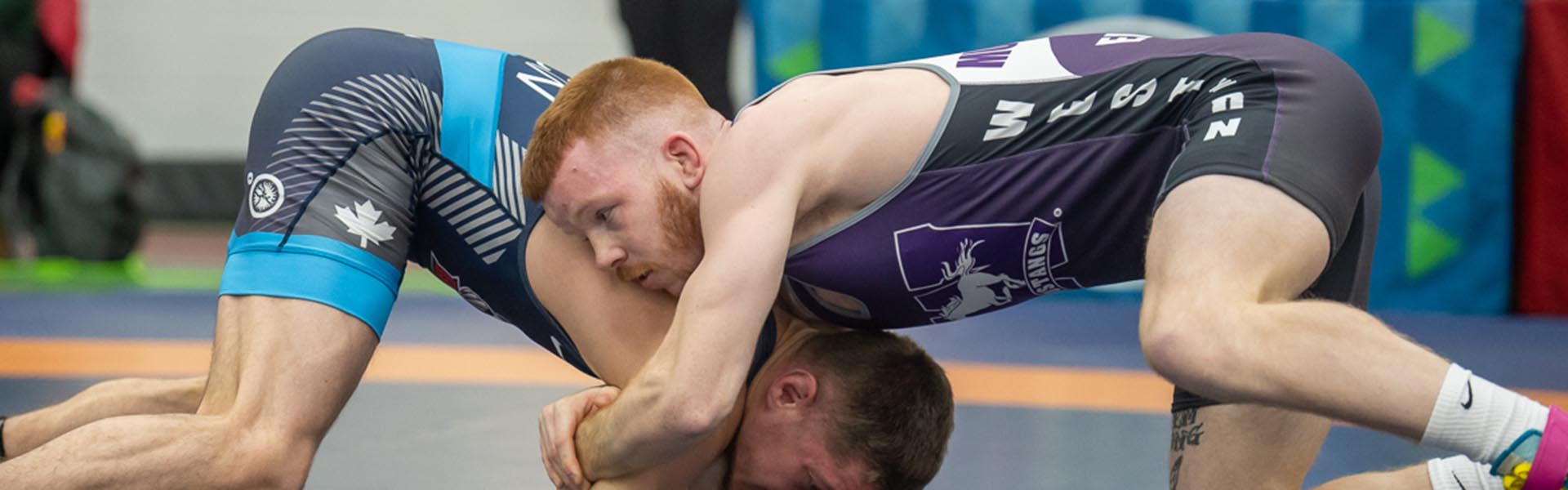 Western Mustangs female wrestler mid-competition