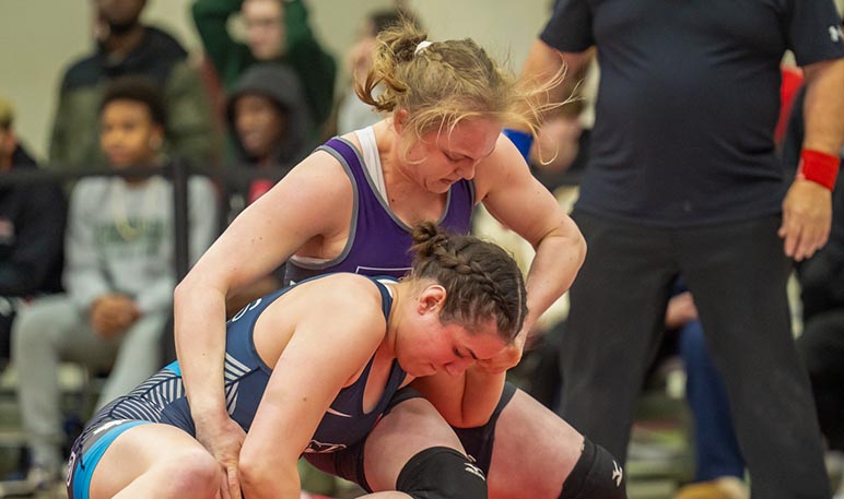 Western Mustangs female wrestler mid-competition