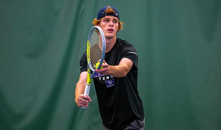 Western Mustangs men’s tennis player mid-game