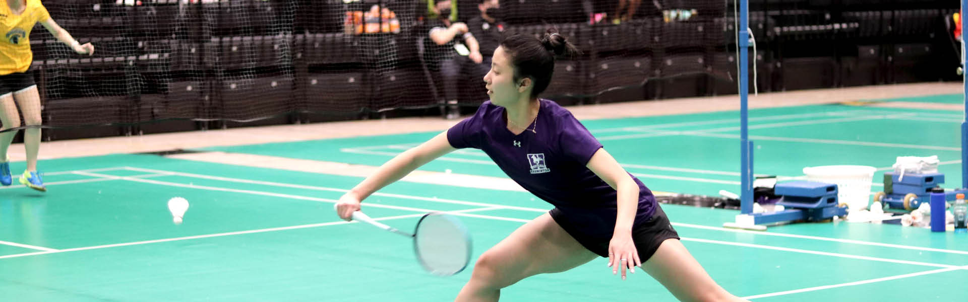 Western Mustangs women’s badminton player lunging for the birdie