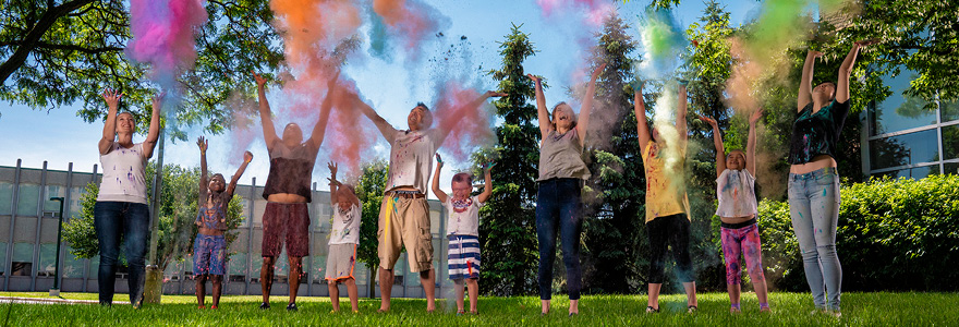 People throwing colourful dust