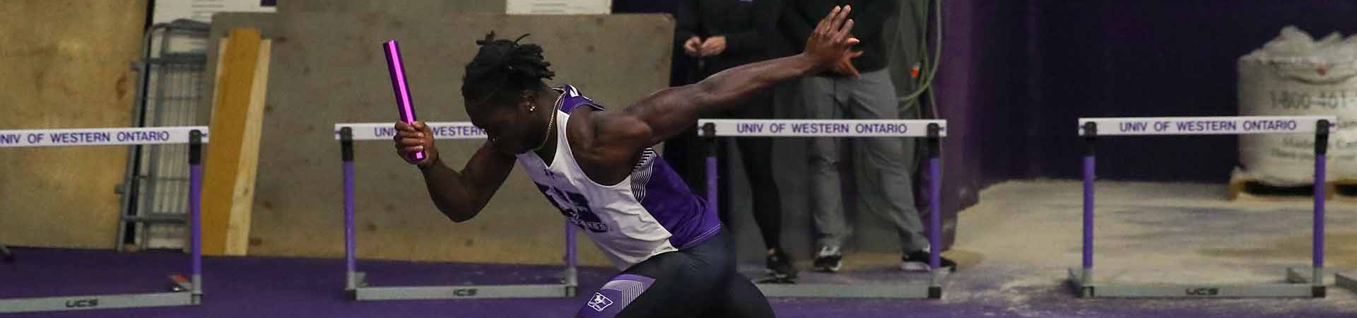 Western sprinter running with a relay baton