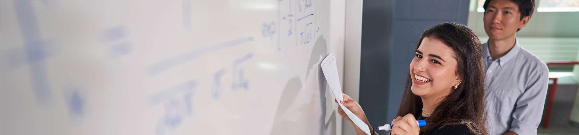 Student writing on a whiteboard