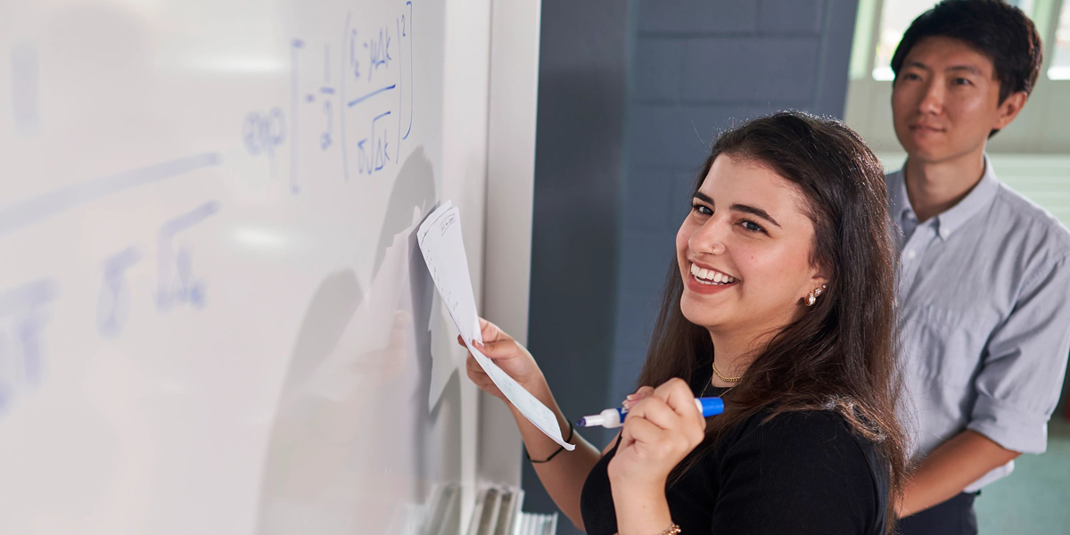 Student writing on a whiteboard