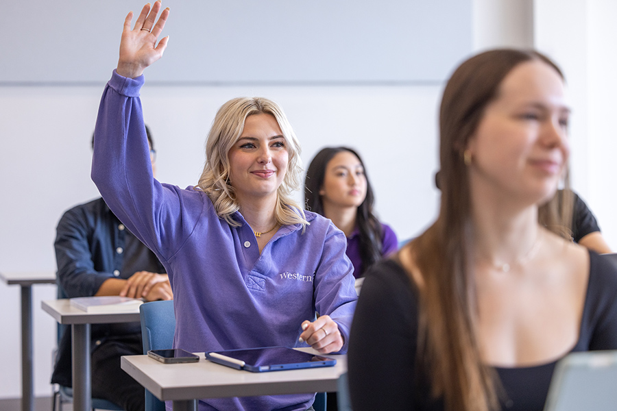 A student with their hand raised