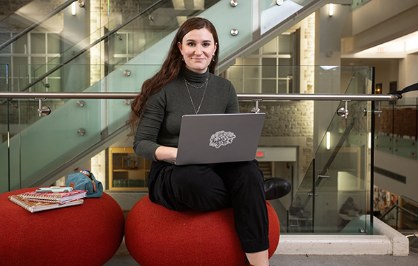 Madelaine photo 1 Madelaine Menegoni sitting indoors using a laptop