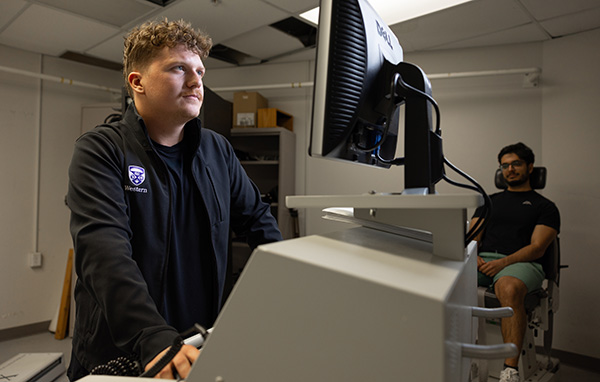 Aaron Beier uses a computer for a patient