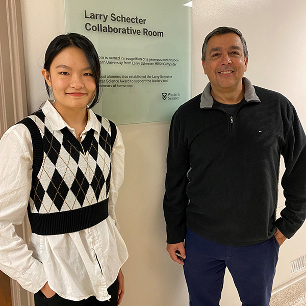 Anny Zheng, the first recipient of the Larry Schecter Computer Science Award standing with Larry outside of the room named in his honour.
