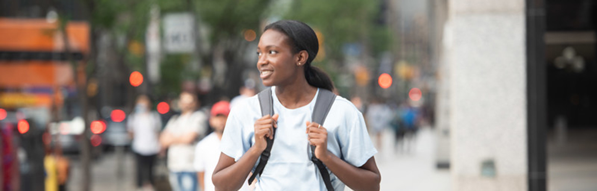 Favour Okpali walking in downtown Toronto.